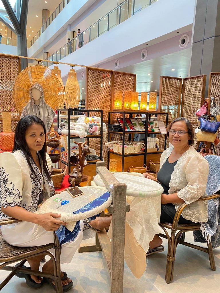 in photo: Ms. Gina Aniciete Domingo, owner of Zia Kindra Embroidery Shop, wearing her embroided barong.