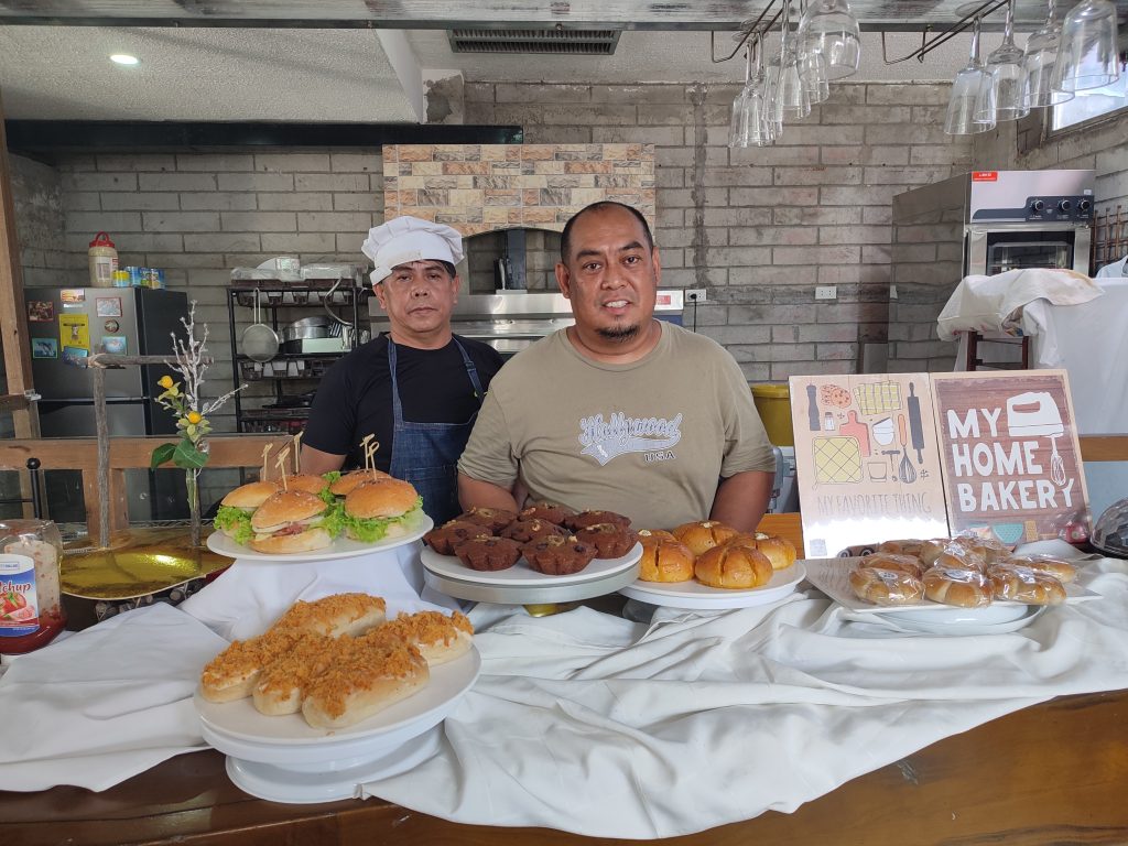 Mr. Paulo Mendoza, together with his bread and pastry products.