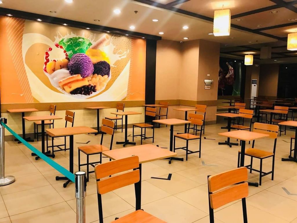 Tables and chairs placed at a safe social distance in a restaurant  in a mall in Region 9