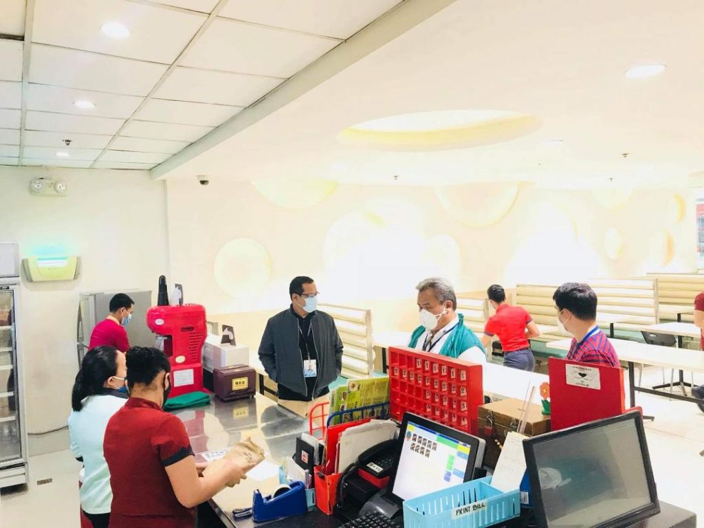 DTI inspectors and restaurant service crew wearing masks in a restaurant  in a mall in Region 9