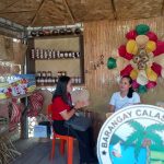 Negosyo Center–Polillo Business Counselor Mabelle V. Samas, evaluating one of the booths as one of the exhibitor.