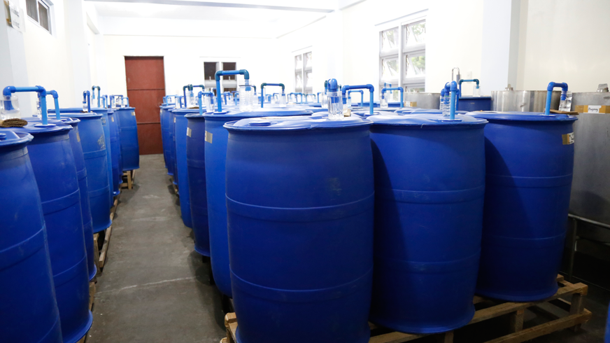 Drums of fermented fruit extract, ready to be processed