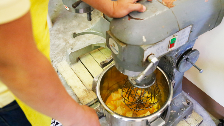 An employee of RichBlitz Sweets mixing ingredients