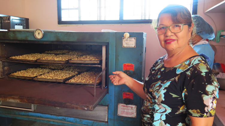 Alcala Women’s Rural Improvement Club Manager Emma Batung showing the oven where the nuts are cooked