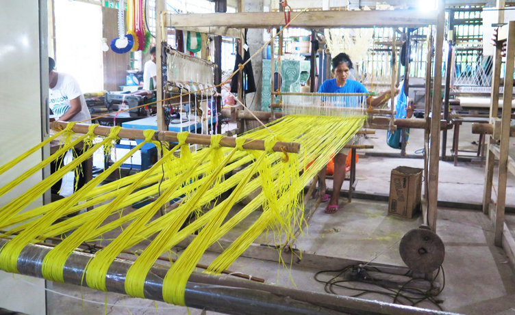 Another TLMPC member painstakingly working on a loom-weaver