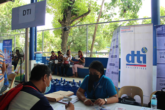 DTI-10 TIDS Blessie G. Cimacio gives consultation services to clients as part of TI-10’s information campaign during the Duterte Legacy: Barangayanihan Caravan Towards National Recovery at Camp Alagar, Lapasan, Cagayan de Oro City held on April 27, 2022.