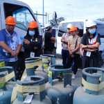 Regional Director Membrere with the rest of DTI Region 1 staff inspecting confiscated LPG tanks.